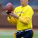 A member of the Maize team baubles the ball during the Victors Classic alumni football game at Michigan Stadium on Saturday. Melanie Maxwell I AnnArbor.com